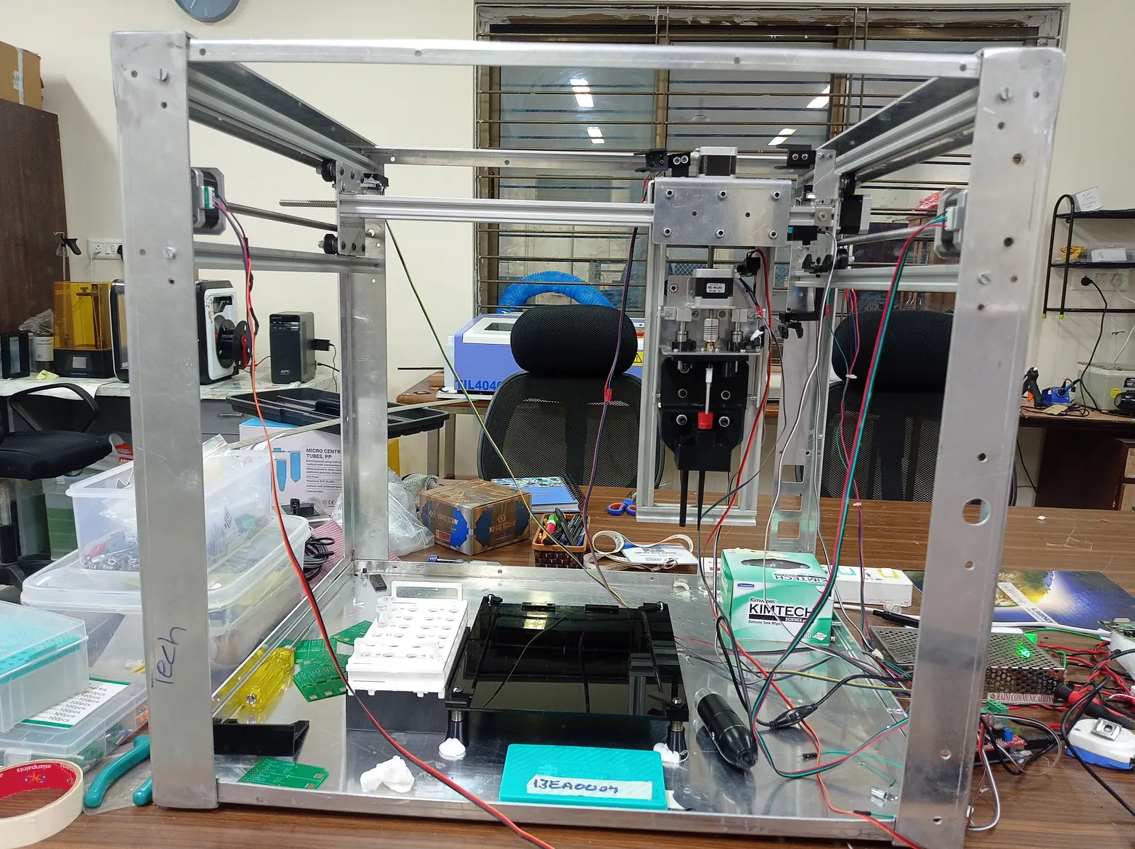 The 5-axis deposition rig, first full assembly — extruded frame, lead screws, and the head that had to land material on a 100µm spot.