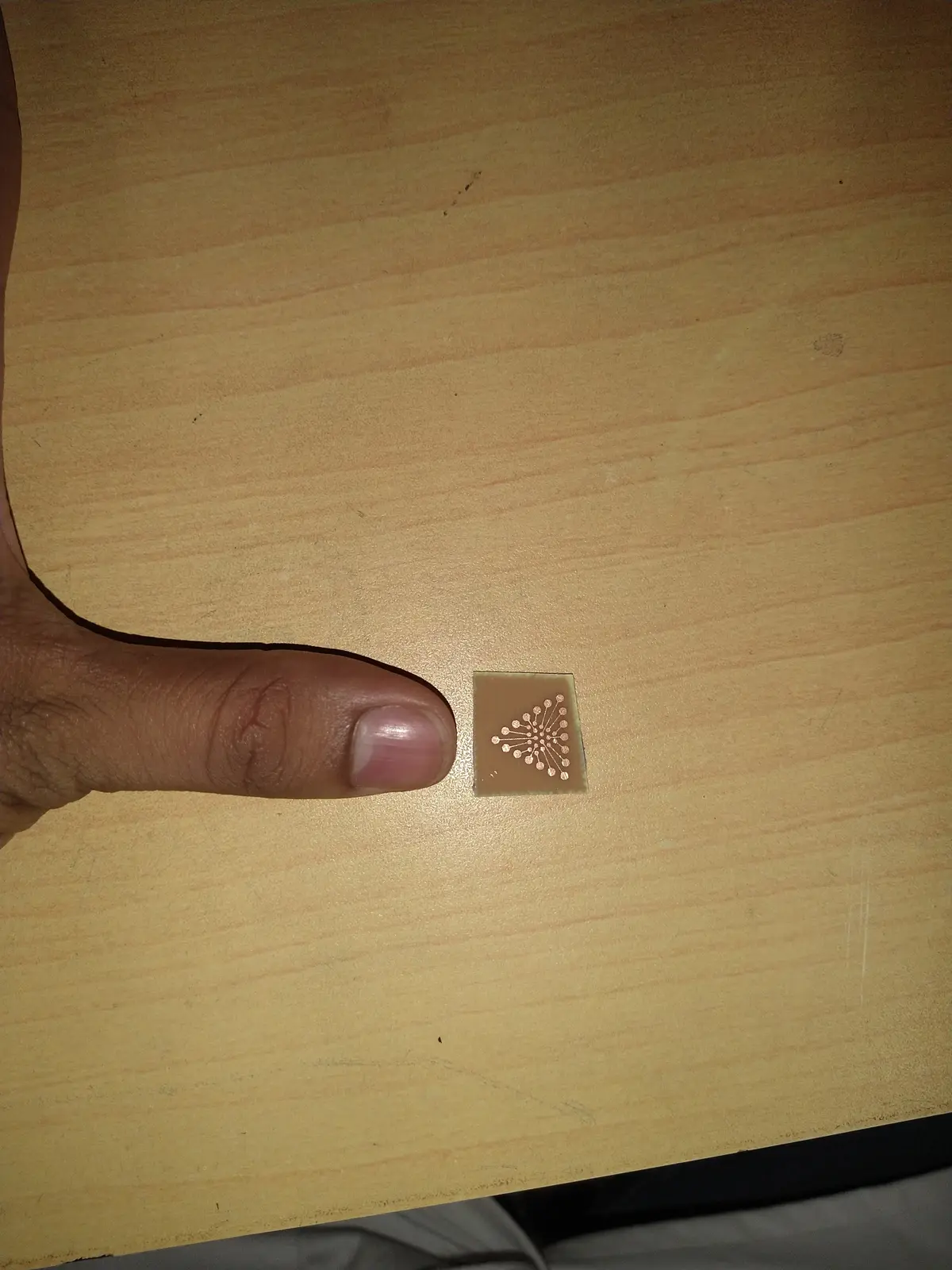Eighteen electrodes fanned out across a chip the size of a fingertip, etched down to 50µm traces.